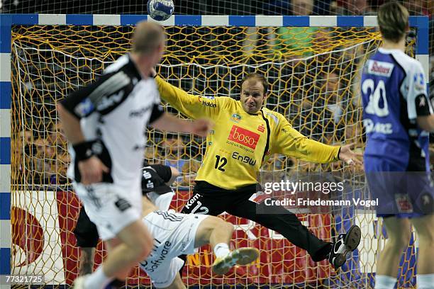 Markus Ahlm of Kiel scores a goal against Milos Slaby of Balingen during the Bundesliga Handball match between THW Kiel and HBW Balingen-Weilstetten...