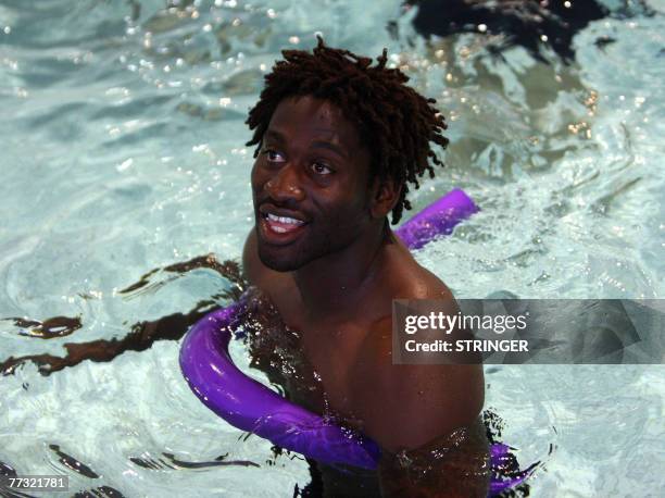 England's winger Paul Sackey enjoys a recovery session at a swimming pool 14 October 2007 in Courbevoie, near Paris. England won against France 14 -...