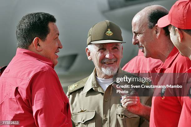 Hugo Chavez , President of Venezuela, talks to Ramiro Valdes, Commander of the Cuban Revolution, and Carlos Lage , Vice President of Cuba, as he...