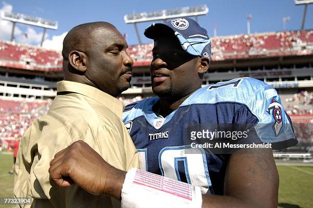 Retired quarterback Doug Williams of the Tampa Bay Buccaneers talks with quarterback Vince Young of the Tennessee Titans at Raymond James Stadium on...