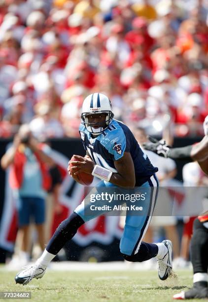 Quarterback Vince Young of the Tennessee Titans scrambles during the game against the Tampa Bay Buccaneers at Raymond James Stadium on October 14,...