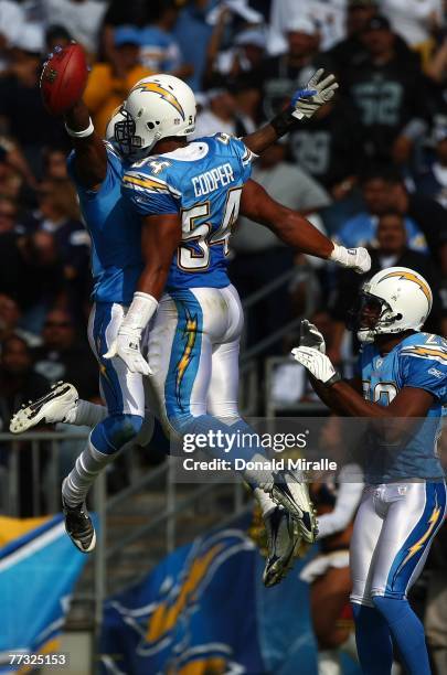 Cornerback Antonio Cromartie of the San Diego Chargers celebrates with teammates Stephen Cooper and Chris Carr after his interception during the 2nd...