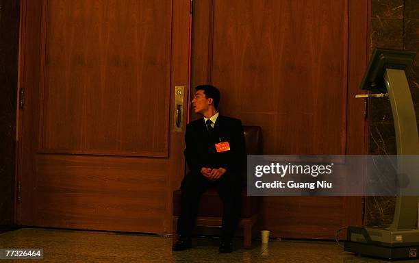 Chinese military officer guards during the opening session of the five-yearly Chinese Communist Party Congress at the Great Hall of the People on...