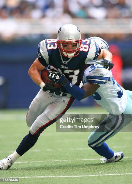 Wide Receiver Wes Welker of the New England Patriots tries to elude the tackle of Corner Back Nathan Jones of the Dallas Cowboys at Texas Stadium on...