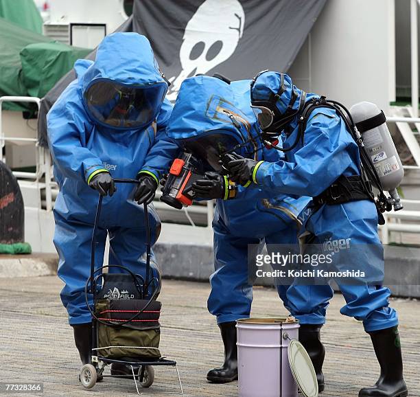 Members of Kanagawa Prefectural Police exercise the removal of unidentified chemical substances with an anti-chemical suit during the Proliferation...