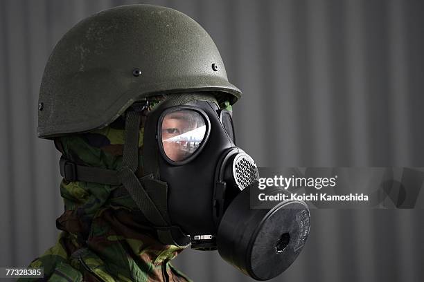 Member of the Singapore army wear gas masks while standing in exercise the removal of unidentified chemical substances with an anti-chemical suit...