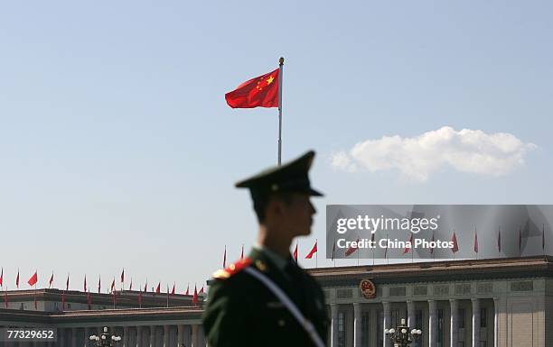 Paramilitary policeman guards in front of the Great Hall of the People, where the 17th National Congress of the Communist Party of China is held 2on...