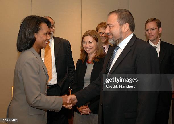 In this handout image provided by the U.S. Embassy Tel Aviv Press Section, U.S. Secretary of State Condoleezza Rice shakes hands with Israeli...