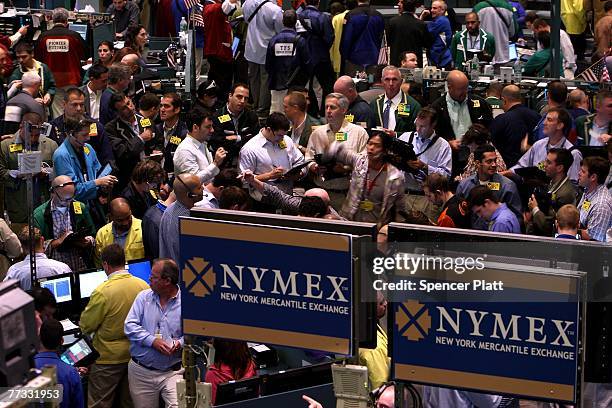 Traders work on the floor of the New York Mercantile Exchange October 15, 2007 in New York City. World oil prices rose Monday, breaking 85 dollars...