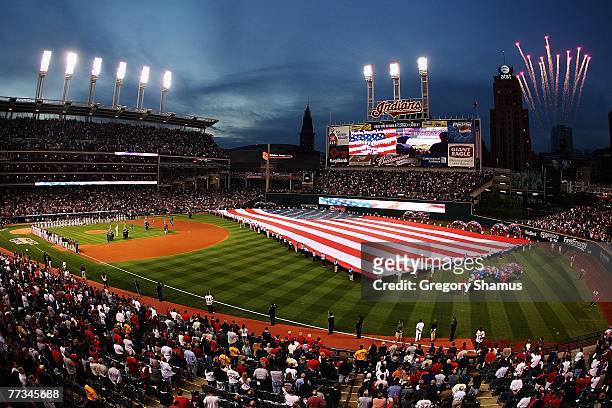 The American flag is seen on the field during the National Anthem prior to the start of Game Three of the American League Championship Series between...