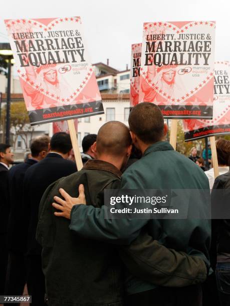 Frank Capley and his partner Joe Alfano hug as they hold signs during a same sex marriage demonstration October 15, 2007 in San Francisco,...