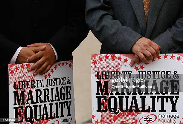 Two gay men hold signs during a same sex marriage demonstration October 15, 2007 in San Francisco, California. About a dozen same-sex couples held a...