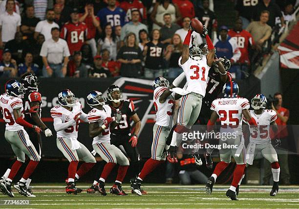 Cornerback Aaron Ross of the New York Giants grabs in interception on a hail mary pass attempt on the last play in the first half while taking on the...