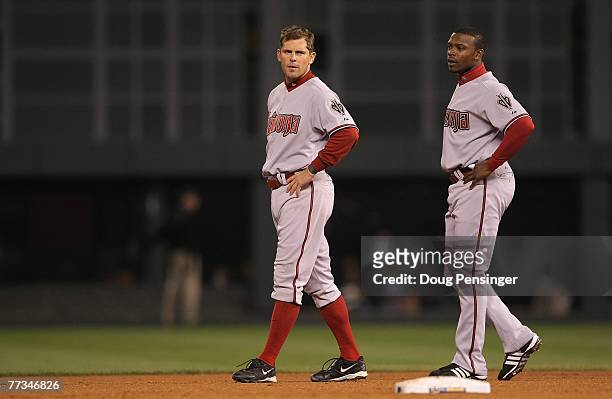 Jeff Cirillo and Justin Upton of the Arizona Diamondbacks look on after Cirillo grounded out to end the top of the second inning against the Colorado...