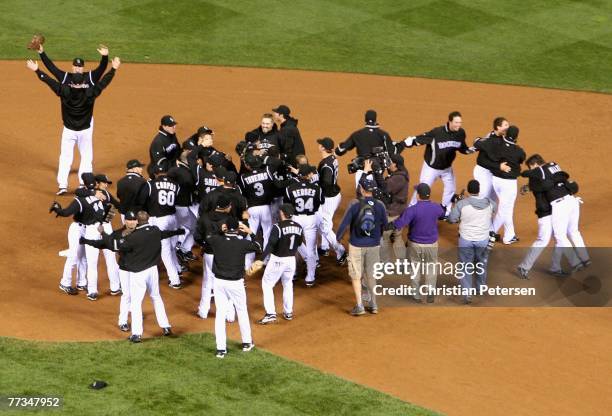 The Colorado Rockies celebrate after defeating the Arizona Diamondbacks in Game Four of the National League Championship Series at Coors Field on...