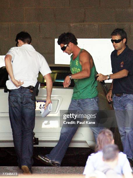 Police escort AFL player Ben Cousins into Curtin House for questioning after being arrested in Perth October 16, 2007 in Perth, Australia.