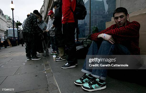 Calum Nelson who waited 3 days and 3 nights to be the first person to purchase the Limited Edition 'What The Dunk Shoes' sits outside Nike Town on...