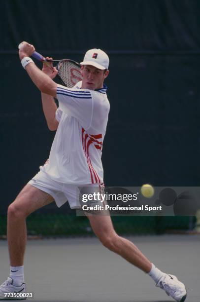 Canadian born British professional tennis player Greg Rusedski of the Great Britain team, pictured in action during competition to reach the third...