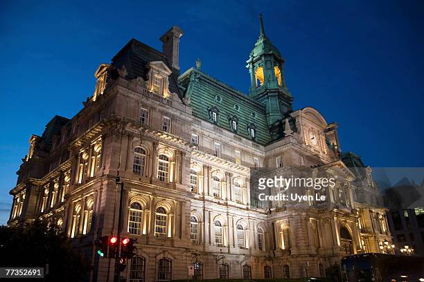 dusk photograph of the hotel de ville (city hall) building in montreal, quebec, canada. - hotel de ville montreal stock pictures, royalty-free photos & images
