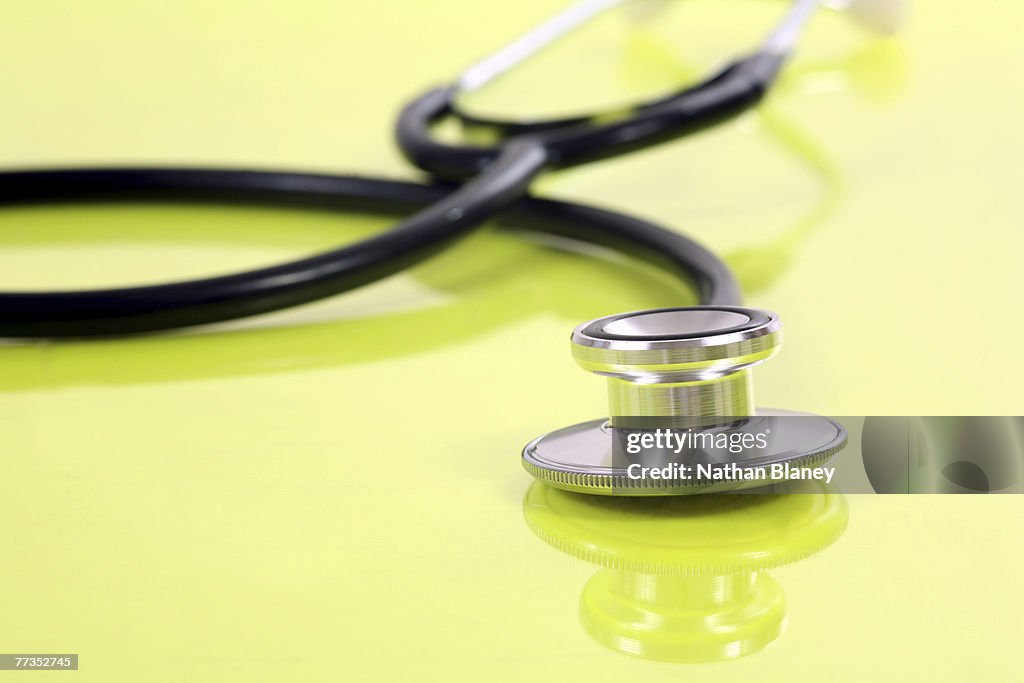 Stethoscope on colored surface.