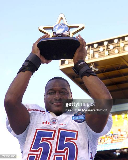 Tampa Bay Buccaneers linebacker Derrick Brooks holds up the most valuable player trophy February 12, 2006 at the Pro Bowl at Aloha Stadium in...