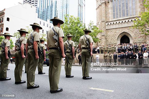 Soldiers stand to attention after the military funeral for Trooper David Pearce at the Cathedral of Saint Stephen on October 17, 2007 in Brisbane,...
