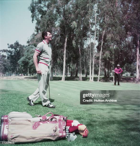 American actor and singer Dean Martin playing golf, circa 1960.