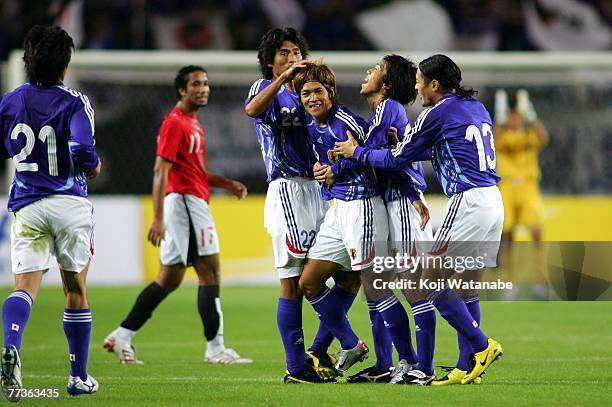 Yoshito Okubo of Japan celebrates after scoring with his teammate Yuji Nakazawa during the AFC Challenge Cup match between Japan and Egypt at Nagai...