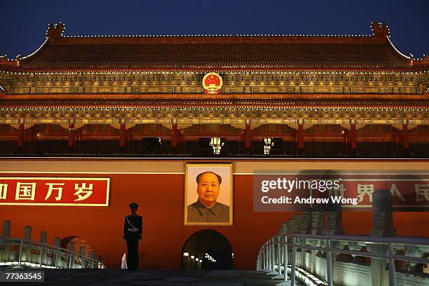 Policeman stands guard underneath the Tiananmen Gate near the Great Hall of the People on the third day of the Chinese Communist Party Congress...