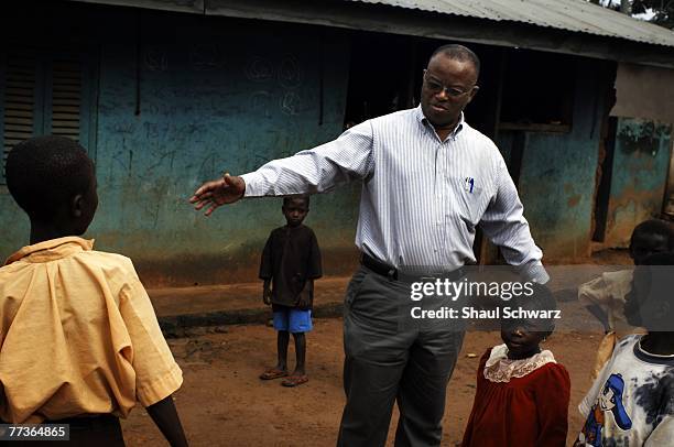 Children at the rural village of Kokmua run in front of a mud house September 19, 2007 in Ghana, Africa. The village is a part of the DSS ?...