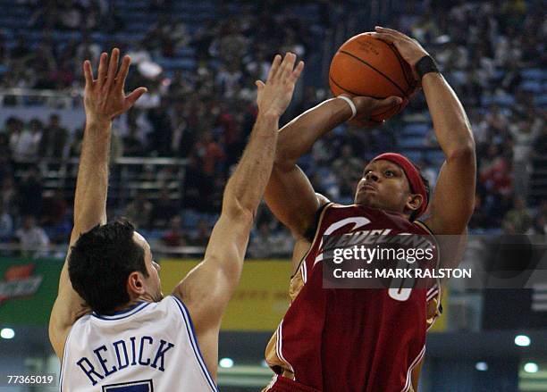 Orlando Magic player J.J. Redick tries to block Shannon Brown from the Cleveland Cavaliers during their NBA China Games 2007 exhibition basketball...