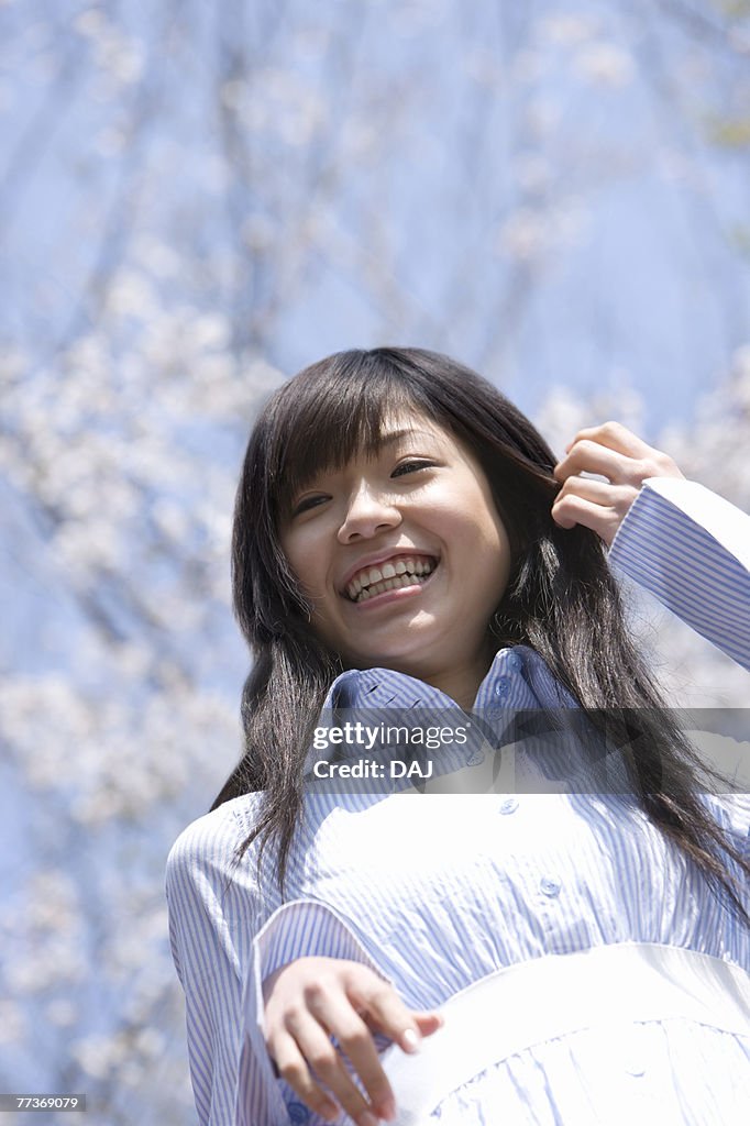 Young Woman and Cherry Blossom in the Background, Low Angle View