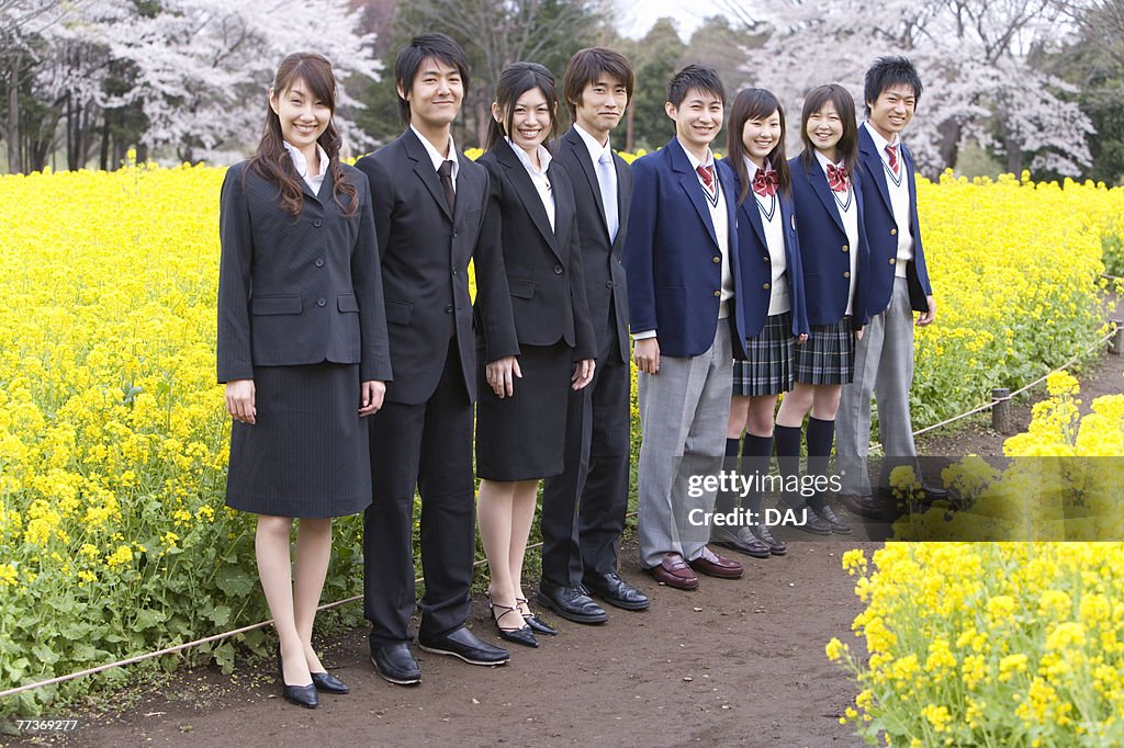 Students and New Business People Standing in a Line, Side View, Full Length