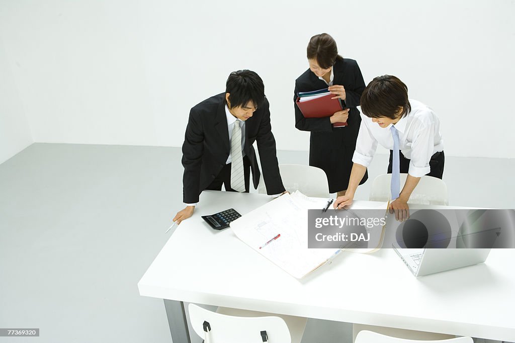 Businessmen and Businesswoman In Meeting, High Angle View