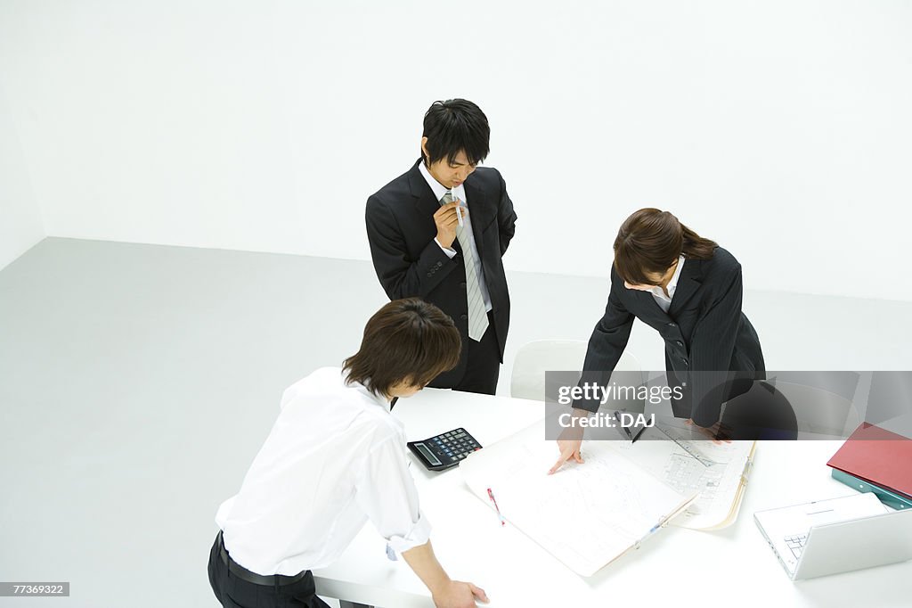 Businessmen and Businesswoman In Meeting, High Angle View