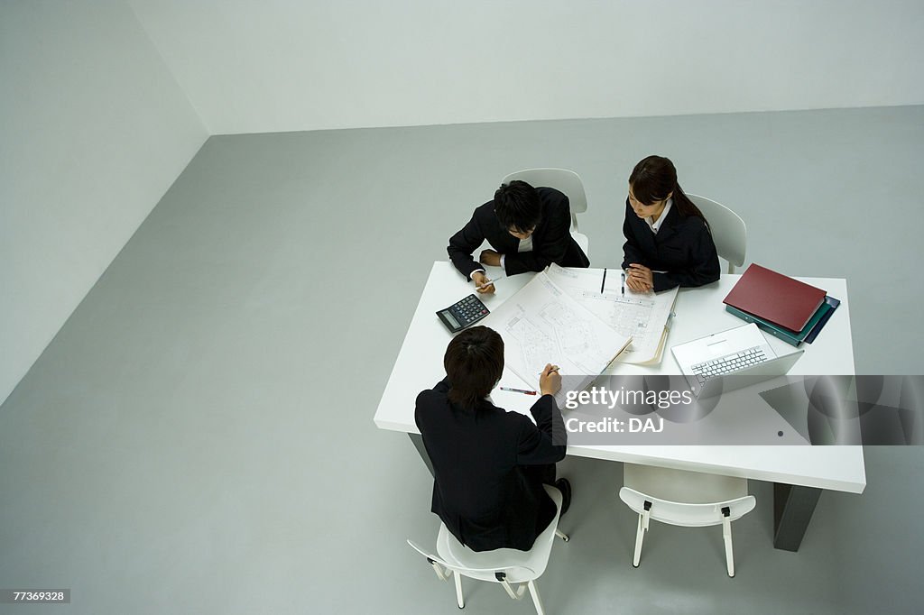 Businessmen and Businesswoman In Meeting, High Angle View