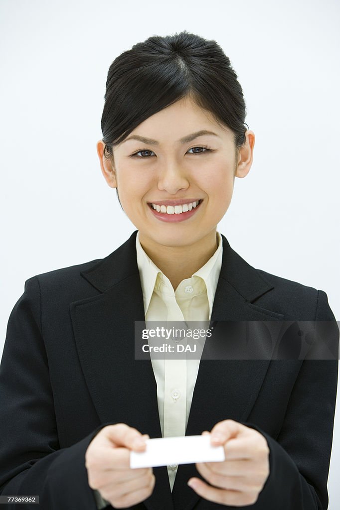 Businesswoman Exchanging Business Cards, Smiling, Three Quarter Length, Front View