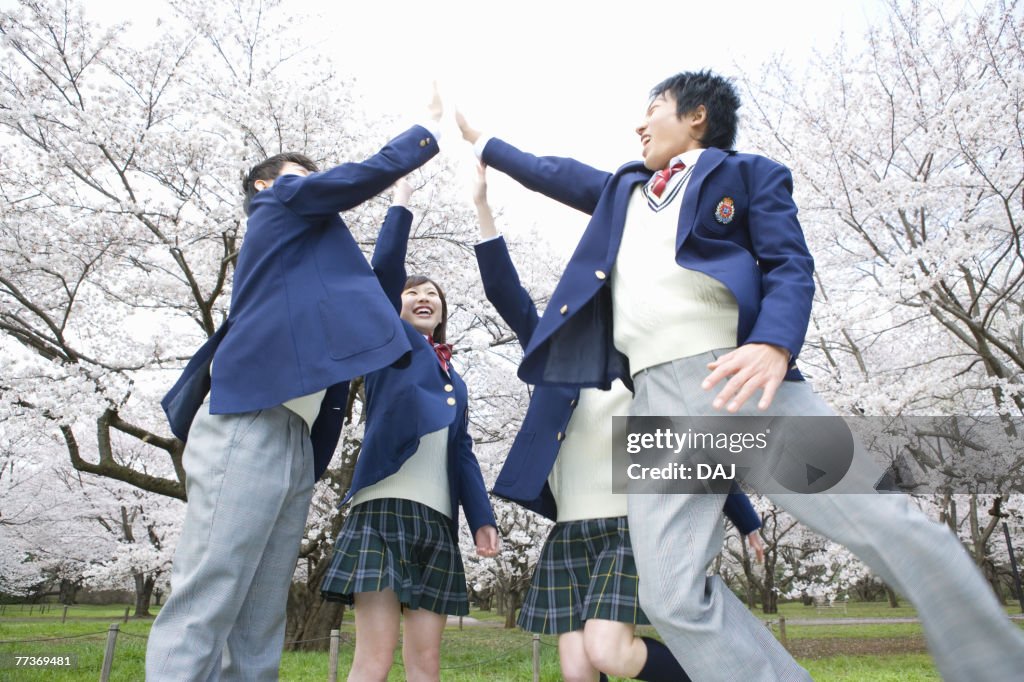 High School Students Jumping and Giving Each Other High-five