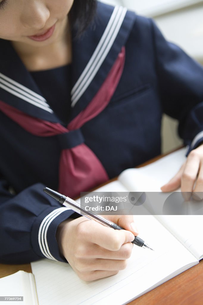 Teenage girl studying at desk