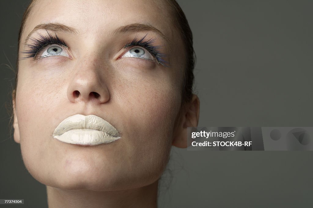 Young woman with white colored lips (part of), close-up