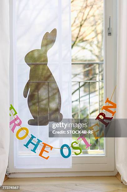 garland with a slogan hanging on a window, close-up - easter bunny letter stock pictures, royalty-free photos & images