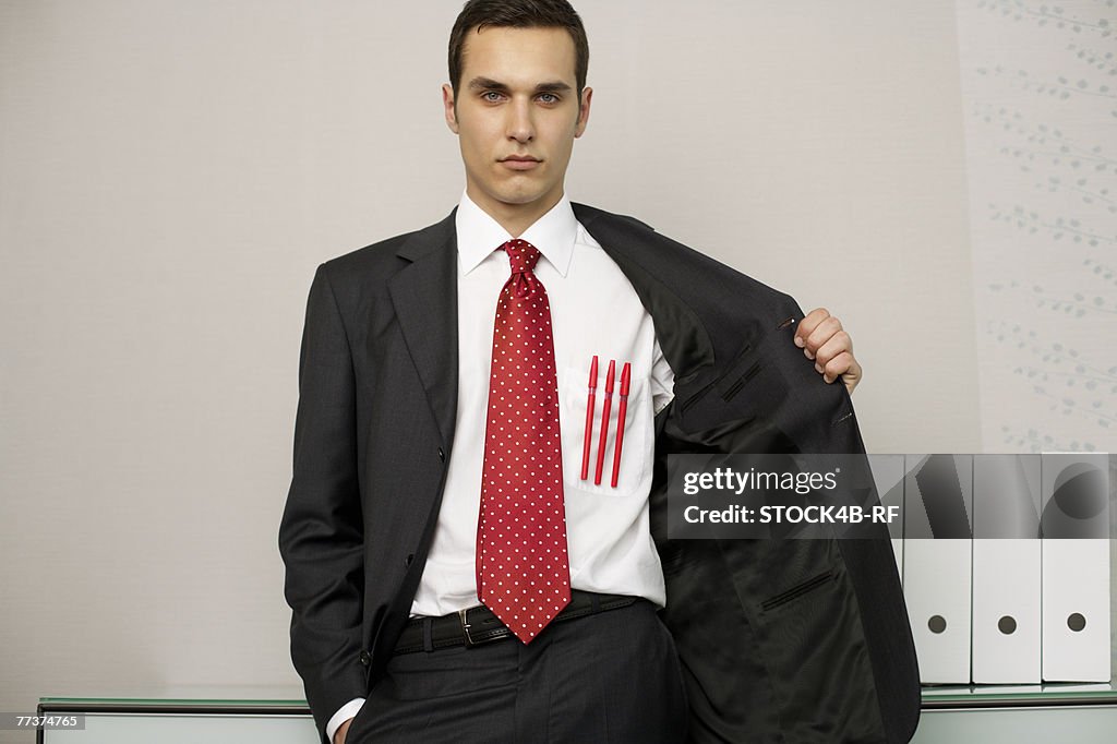 Businessman with three pens in front pocket, portrait