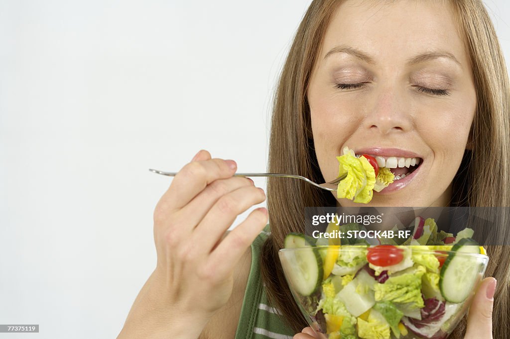 Mid adult woman eating salad