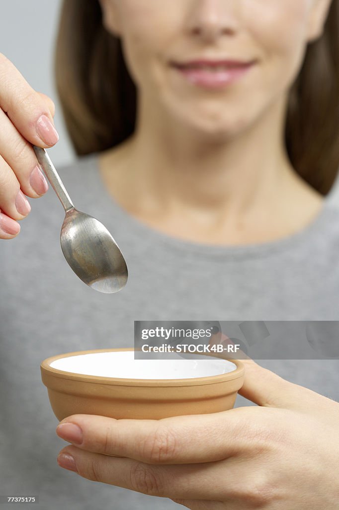 Woman holding a dish and a spoon