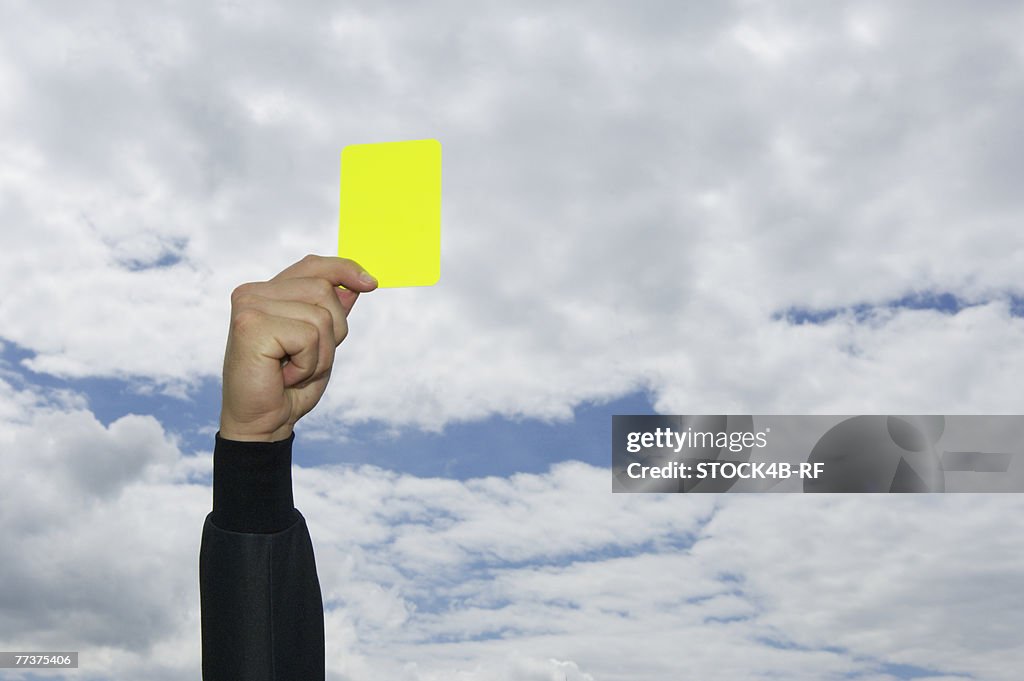 Referee showing yellow card