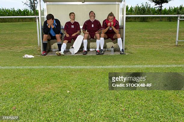 disappointed kickers sitting on substitutes' bench - sub 20 stockfoto's en -beelden