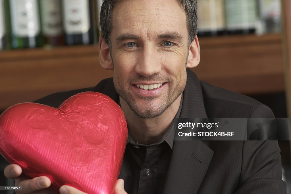 Man holding a chocolate heart