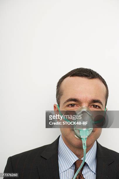 businessman with oxygen mask - rf business stock pictures, royalty-free photos & images