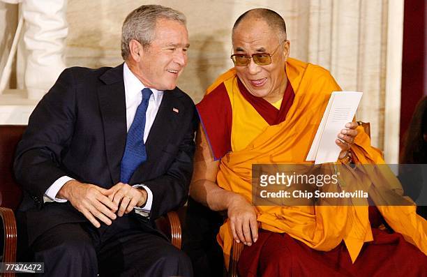 President George W. Bush talks with the Dalai Lama before His Holiness received the Congressional Gold Medal in the U.S. Capitol Rotunda October 17,...