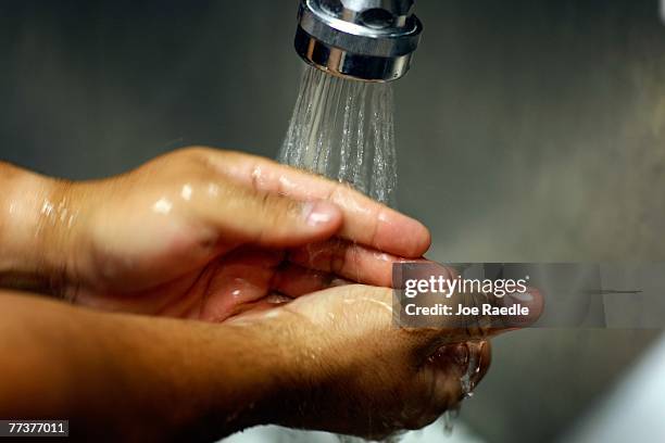 Miami VA Medical Center hospital registered nurse, Rafael Sepulveda, washes his hands in the sink while attending to patients in the Emergency room...